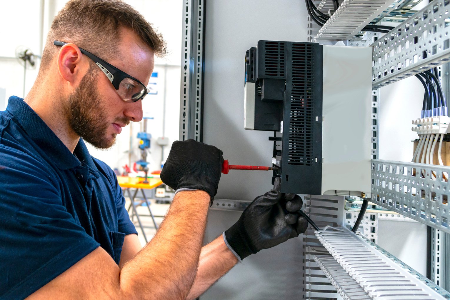 Electrician working at electric panel